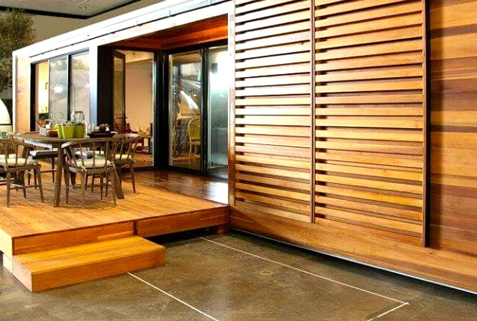 Wood deck with dining table and slatted cedar screen wall