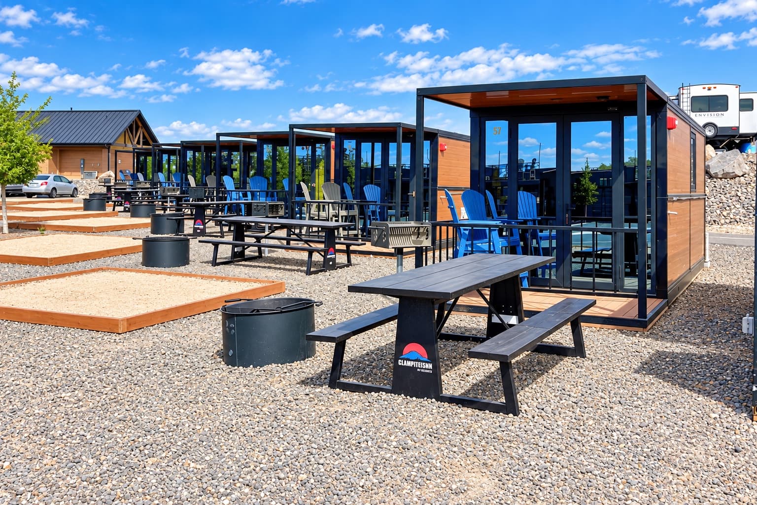 Row of glass-front rental cabins with picnic tables and fire pits at Jellystone Park™ Zion