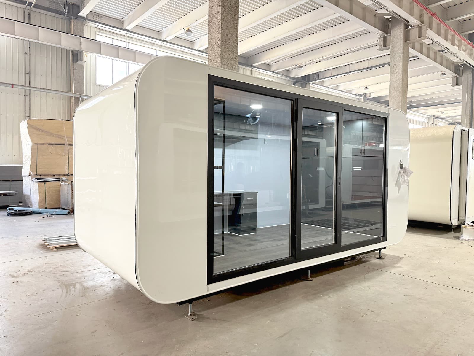X-Executive in white with a three-panel sliding glass front, fresh off the factory line